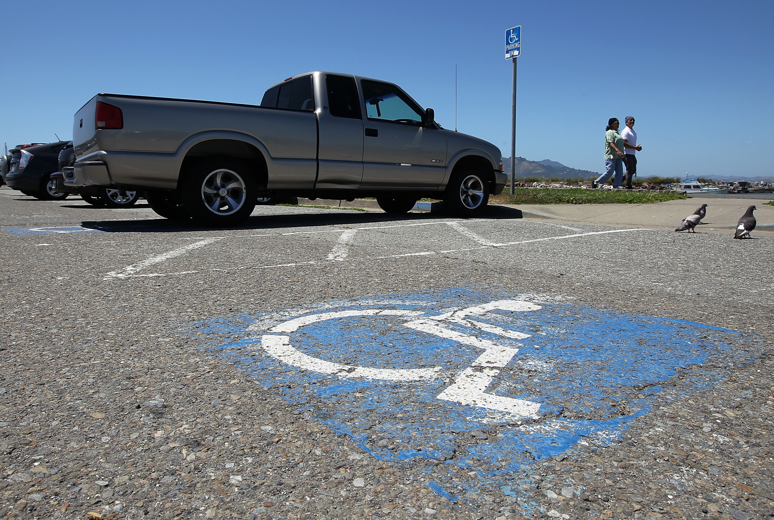 SAN FRANCISCO, CA - JULY 20: A truck is parked in a disabled parking spot on July 20, 2011 in San Francisco, California. The California DMV says that is has sent out nearly 60,000 disabled parking placards to dead people since the DMV only checks state death records every two years. The disabled parking placards allow handicapped motorists to park for free and in designated parking spots.